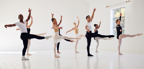 Dancing is the poetry of the foot. a group of ballet dancers practicing a routine in a dance studio.