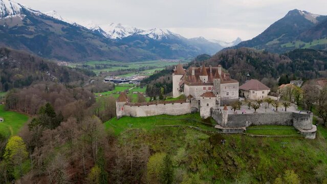 Famous Gruyere Castle in Switzerland also called Schloss Greyerz - aerial view by drone