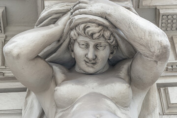 Vienna, Austria - Portrait of balcony support statue as atlas of young and naked sensual Roman renaissance era woman, details, closeup