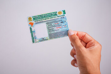 Hand holding driver's license. Brazilian document.