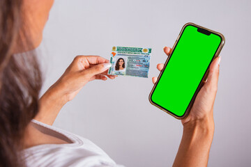 hands holding driver's license and smartphone. Apps.