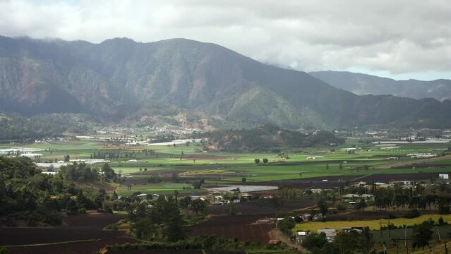 Aerial panoramic view of the green valley with the mountains around. Constanza, Dominican Republic