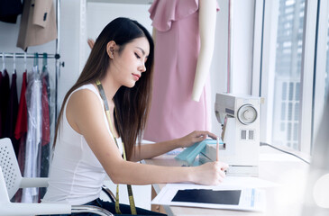 asian female fashion designer working at studio