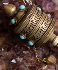 Tibetan prayerwheel on a crystal background