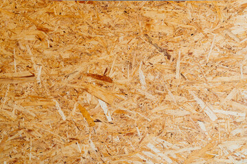 OSB is a building material made of wood chips and resin.