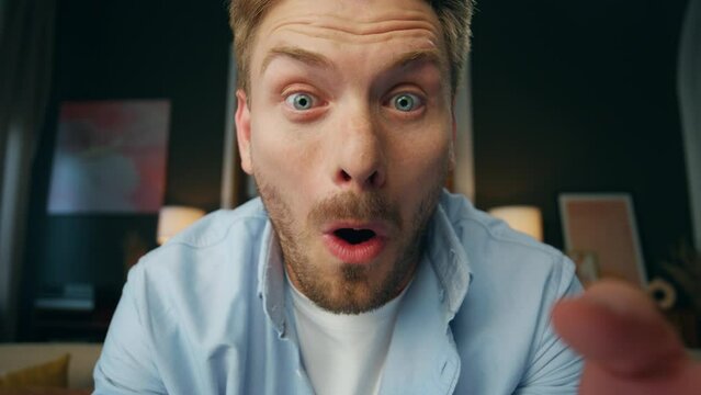 Excited winner saying wow home pov video. Surprised man reading joke laughing
