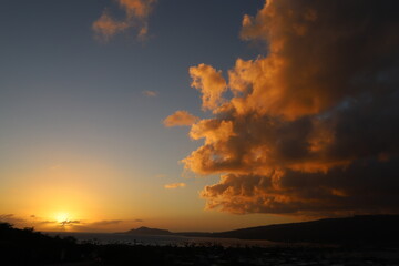 landscape with mountains, clouds, beaches, sky, and orange skies of beautiful Hawaii