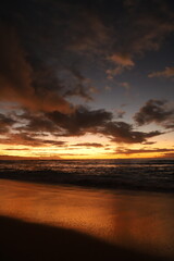 Naklejka na ściany i meble landscape with mountains, clouds, beaches, sky, and orange skies of beautiful Hawaii