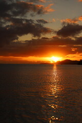 landscape with mountains, clouds, beaches, sky, and orange skies of beautiful Hawaii