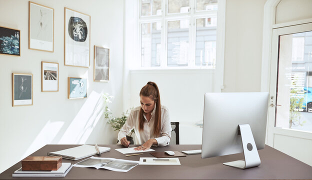 Young female architect working on a design in her office