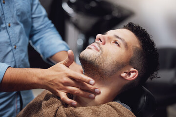 He cleans up good. a handsome young man getting groomed by a barber.
