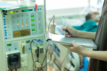 The specialist are checking continuous renal replacement therapy equipment and injection pump and...