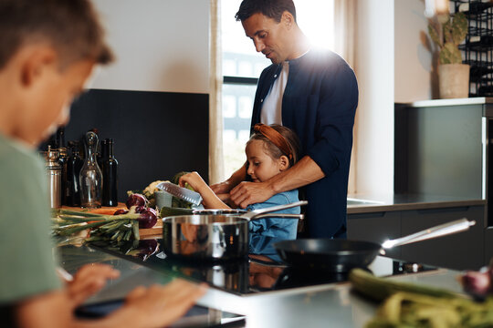 Father and daughter cooking together