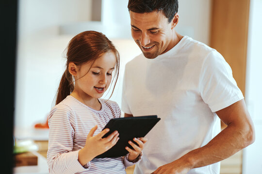 Dad and daughter using a tablet