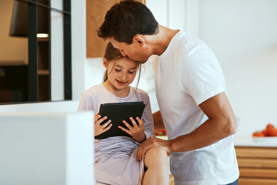 Loving dad and daughter using a tablet