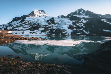 Wrangell-St. Elias National Park and Preserve, Alaska. Sunset view with glacier lake and glaciers with mountains and reflection. USA.