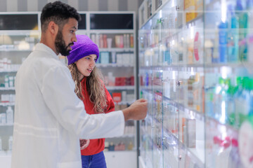 Young pharmacist helping customer to choos medication.