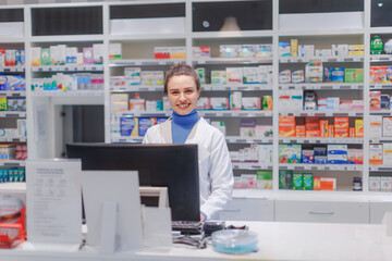Fototapeta na wymiar Portrait of young pharmacist selling medication in pharmacy.