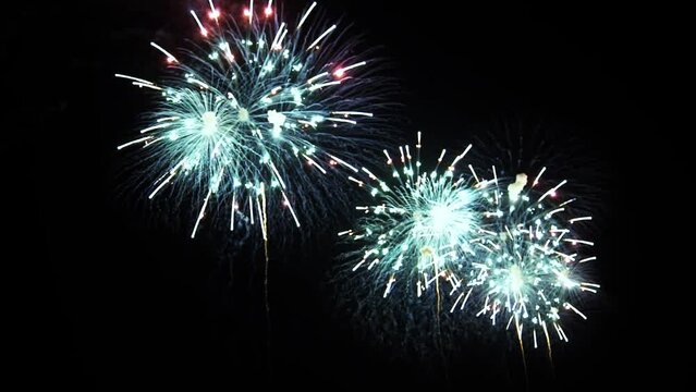 4K. loop seamless of real fireworks background. abstract blur of real golden shining fireworks with bokeh lights in the night sky. glowing fireworks show. New year's eve fireworks celebration.