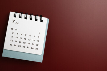 close up of calendar on the red table background, planning for business meeting or travel planning concept