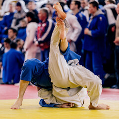Fototapeta premium two judoists are lying on tatami in fight judo competition