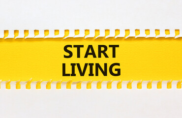 Start living symbol. Concept words Start living on beautiful yellow paper. Beautiful white table...