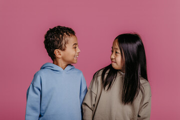 Portrait of two children, studio shoot. Concept of diversity in friendship.