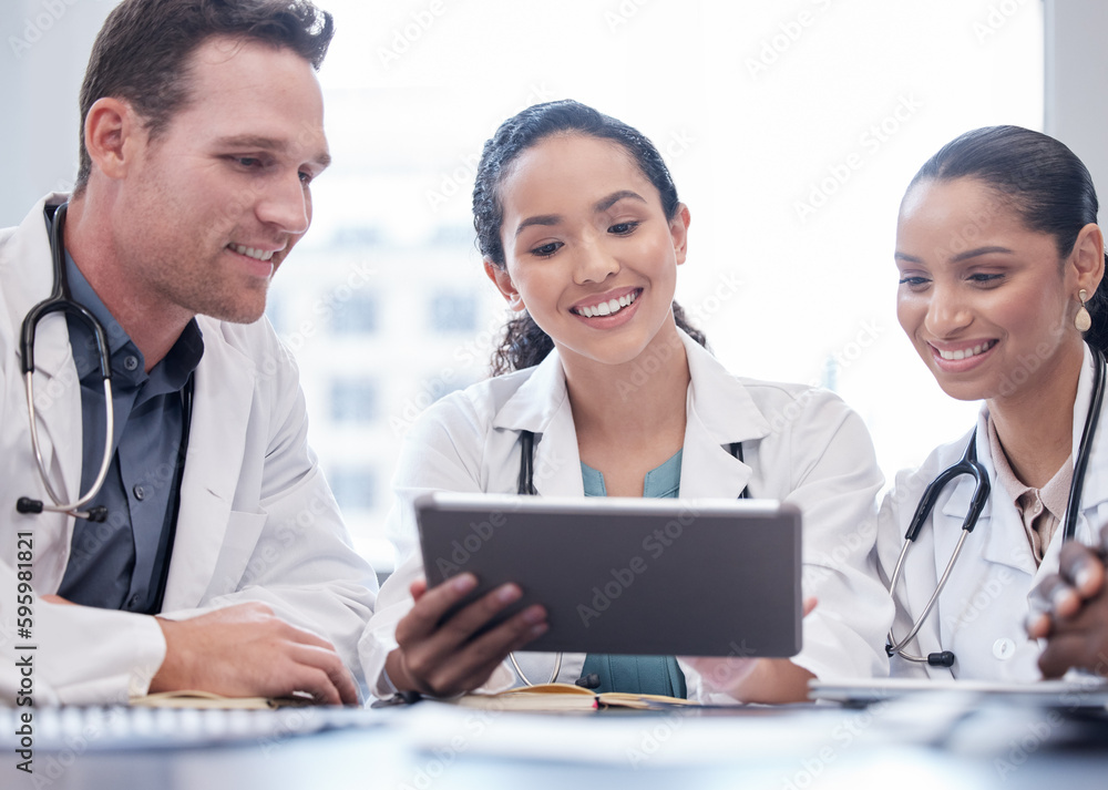 Poster this is such great news. a group of doctors having a staff meeting while using a digital tablet.