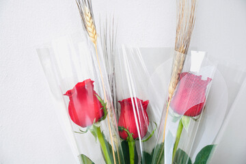 Red roses with white wall and space for text. Sant Jordi's day, popular celebration in Catalonia,...