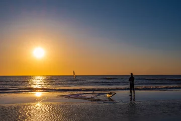 Fototapeten Sunset with surfers on the North Sea beach near Bergen aan Zee/NL © fotografci