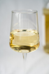 A wineglass of white dry wine. Close-up. Selective focus.