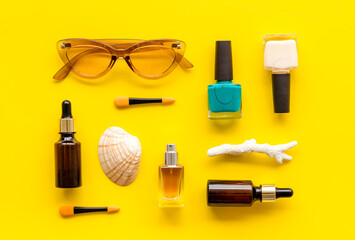 Summer travel cosmetic set with makeup products, top view flat lay