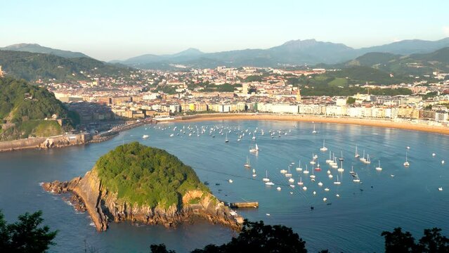 High angle view of San Sebastian - Donostia City. Situated in north of Spain in Vesque Country. View of Santa Clara Island. In background is the city center. Boats docked in the middle of the bay area