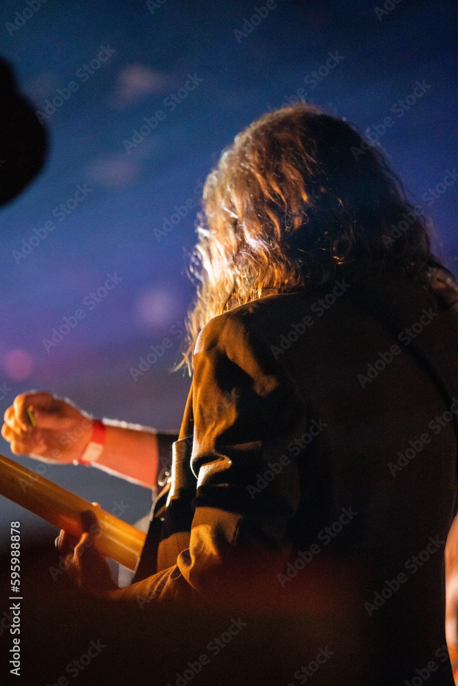 Wall mural band playing music and a gig in a venue, close up of a rock band playing guitars and instruments.