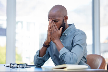 All progress takes place outside the comfort zone. a young businessman feeling stressed while working in a modern office.