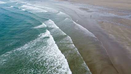waves, top view. Sandy beach and ocean tide. Seascape. Aerial view of ocean waves