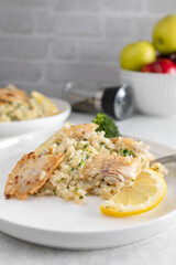Fish with broccoli and brown rice on a plate. Healthy diet or fitness meal