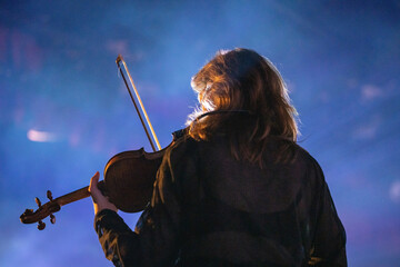 Band playing music and a gig in a venue, close up of a rock band playing guitars and instruments.