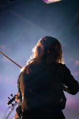 Band playing music and a gig in a venue, close up of a rock band playing guitars and instruments.