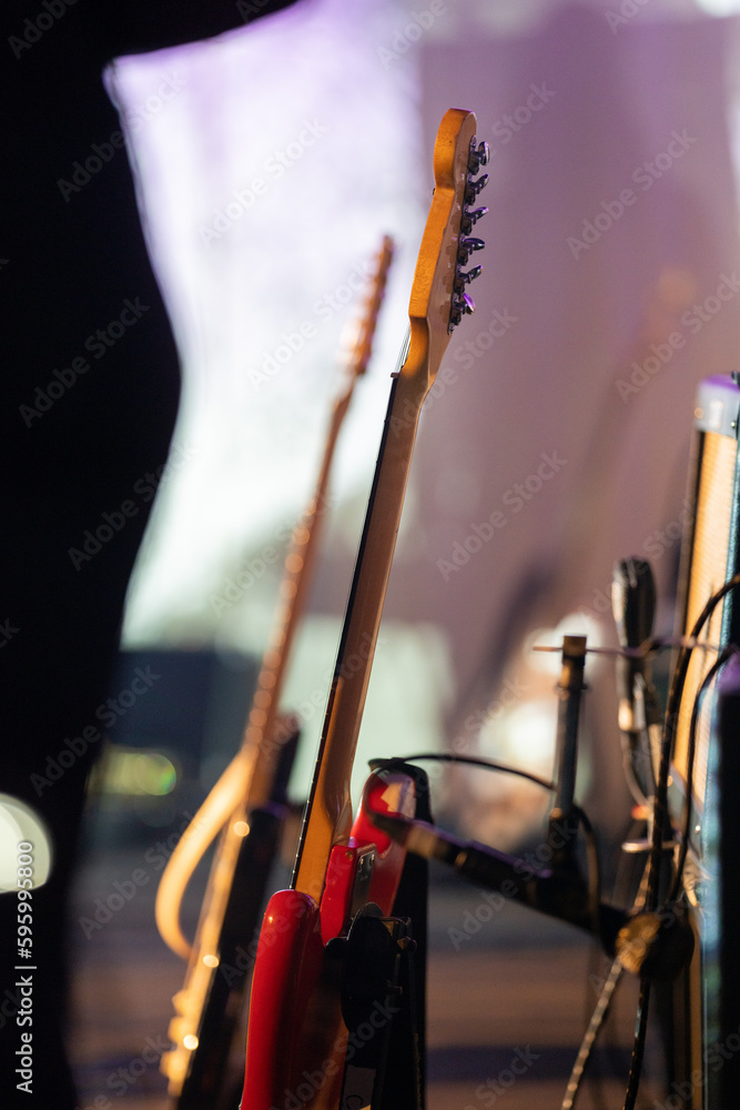 Wall mural band playing music and a gig in a venue, close up of a rock band playing guitars and instruments.