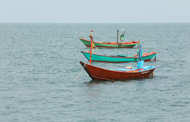 Naklejka na ściany i meble Group of fishing boat floating on the sea.