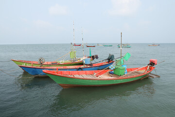 Naklejka na ściany i meble Colorful fishing boat floating on the sea.
