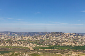 Fototapeta premium Craco, Basilicata. Abandoned city. A ghost town built on a hill and abandoned due to geological problems. Surreal look, horror film scenery. Panorama of the Calanchi Park.