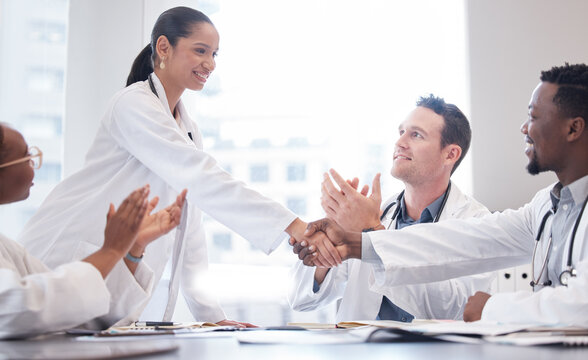 Were so happy to meet you. a group of doctors applauding as a new team member is welcomed aboard during a meeting.