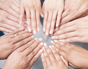 Coming together as one. Shot shot of a group of unidentifiable businesspeople joining their hands together in a unity.