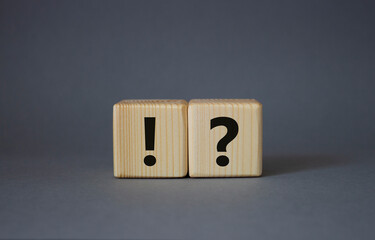 Question mark and exclamation mark symbol. Question mark and exclamation mark on wooden cubes....