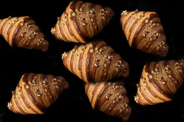 Freshly baked croissants on a black background
