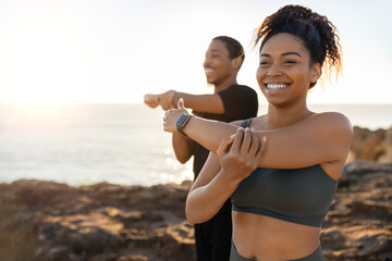 Smiling millennial african american lady and male in sportswear doing arm stretching, enjoy morning