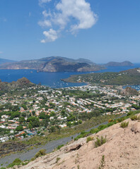 Fototapeta na wymiar Eolias island landscape viewed from vulcano island with town and mediterranean sea