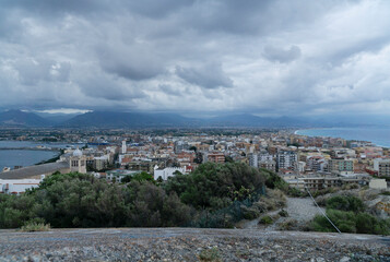 Fototapeta na wymiar Beautiful milazzo city panoramic dusk view from milazzo castle viewpoint with cloudy sky and messina mountains at background